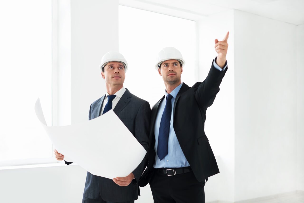 Construction professionals analyzing architectural plans for a building project in Zürich.